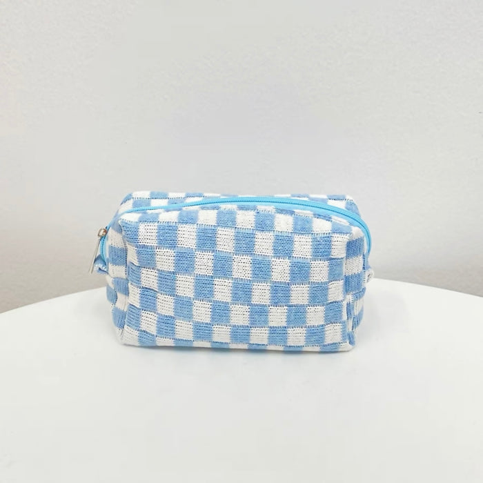 Sky blue checkerboard knit pouch on a white background; minimalist and trendy knit organizer.