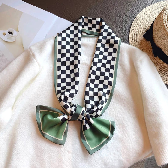 Model wearing a plaid satin scarf in green, easy for weekend styling and gifting.