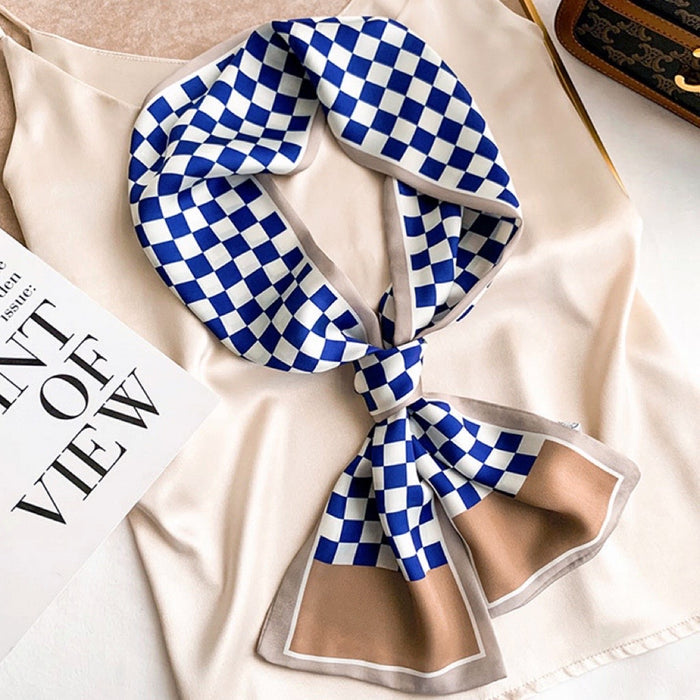 Model wearing a plaid satin scarf in navy and brown and blue, ideal for daily wear and travel.