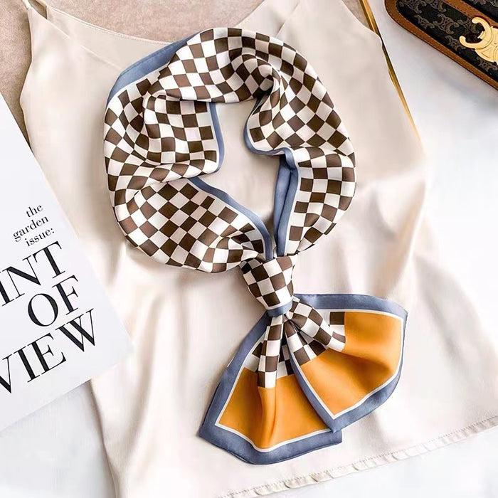 Model wearing a plaid satin scarf in orange, easy for weekend styling and gifting.