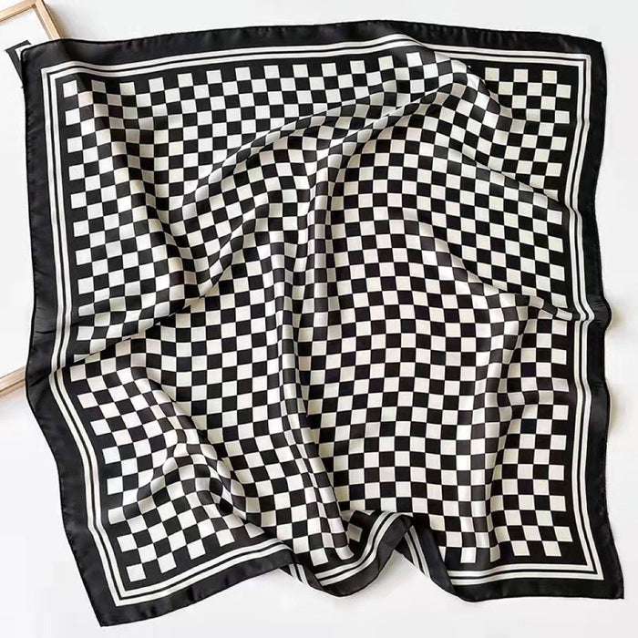 The black and white checkerboard scarf spread out flat to show its full square design.