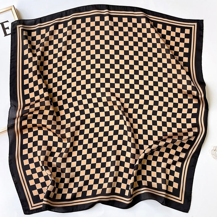 The caramel and black checkerboard scarf spread out flat.