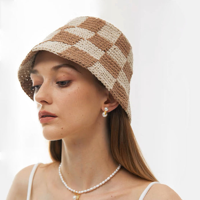 Model wearing a khaki checkered bucket hat, offering a trendy and breathable accessory choice.