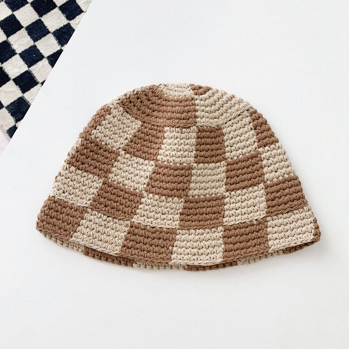 Khaki checkered bucket hat laid flat on a clean background, showcasing its artisanal crochet weave.