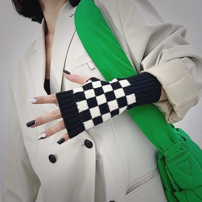 Black checkered gloves with white blazer; chic office-friendly gear for typing in cold workspaces.