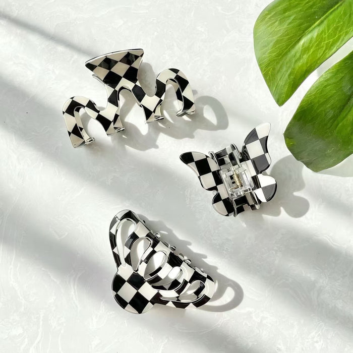 Angled view of  3 checkered hair claws in various shopes , ideal for quick updos and ponytails.