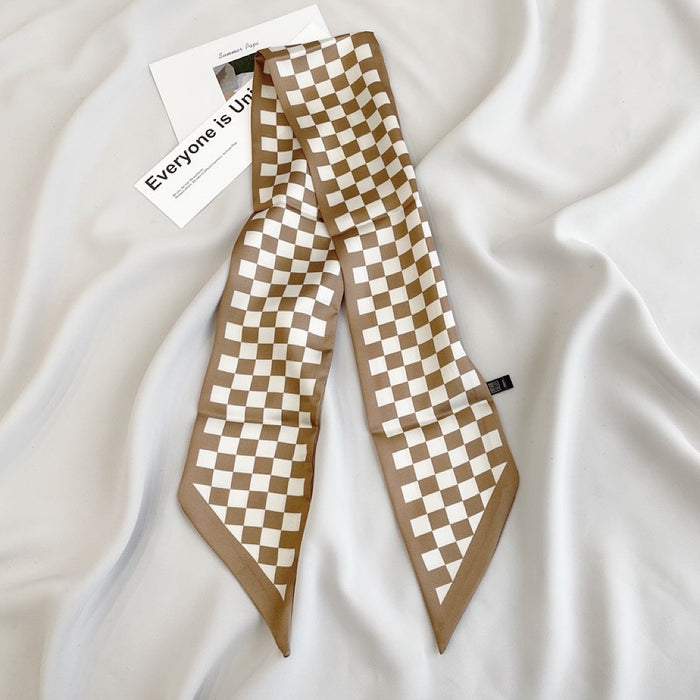 Model wearing a plaid silk scarf Checkered Silk Like Skinny Scarf, easy for weekend styling and gifting.