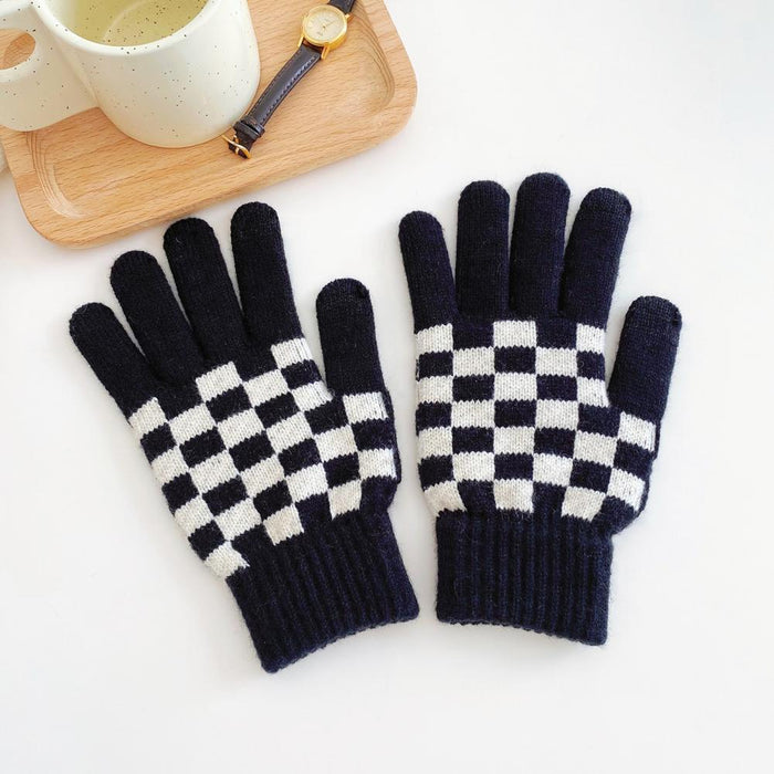 Flat lay checkerboard knitted touch screen gloves in black and white with ribbed cuffs; cozy for winter phone use.