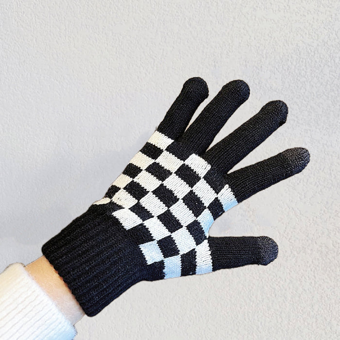 Flat lay checkerboard knitted touch screen gloves, black and cream squares; cozy for winter phone use.