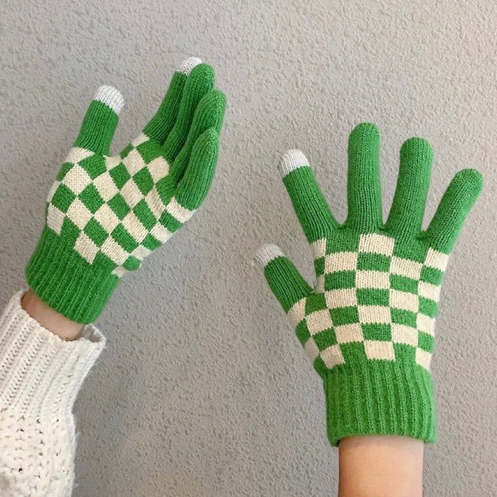 Flat lay checkerboard knitted touch screen gloves with contrasting squares; cozy for cold-weather errands.