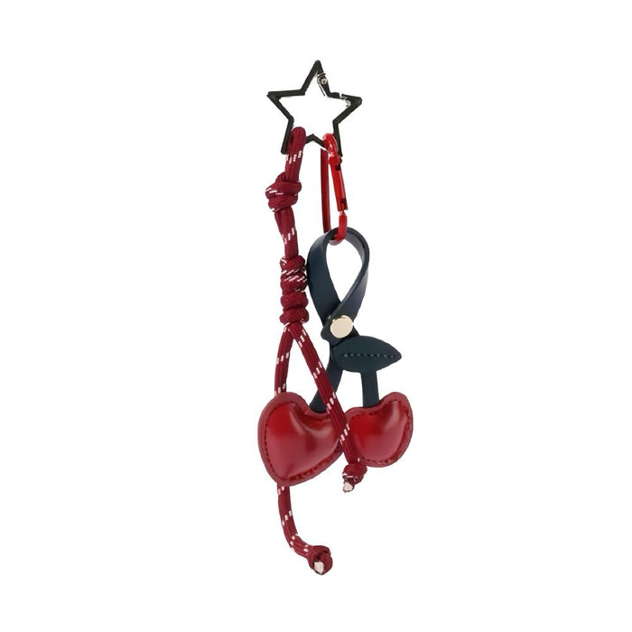 Front view of Red PU leather cherry bag charm with a star keyring and dark blue strap, great for everyday styling.
