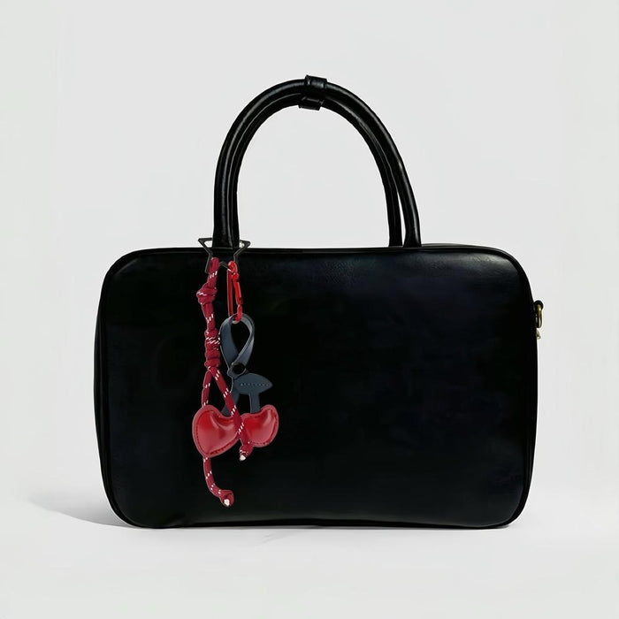 Cherry Bag Charm with rope hanging on a bag, easy for gifting and photo-ready styling.