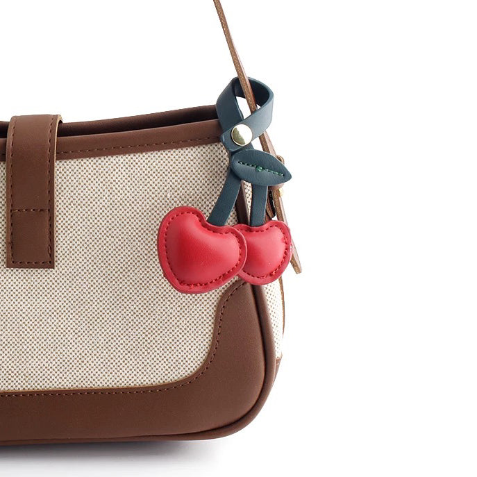 Cherry Bag Charm hanging on a bag, easy for gifting and photo-ready styling.