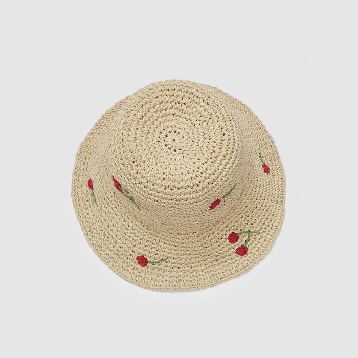 Overhead view showing the intricate straw weave and cherry detail.