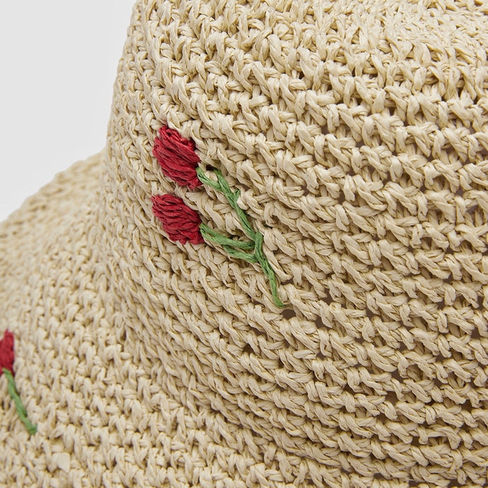 Close-up of the high-quality straw material and cherry embroidery detail.