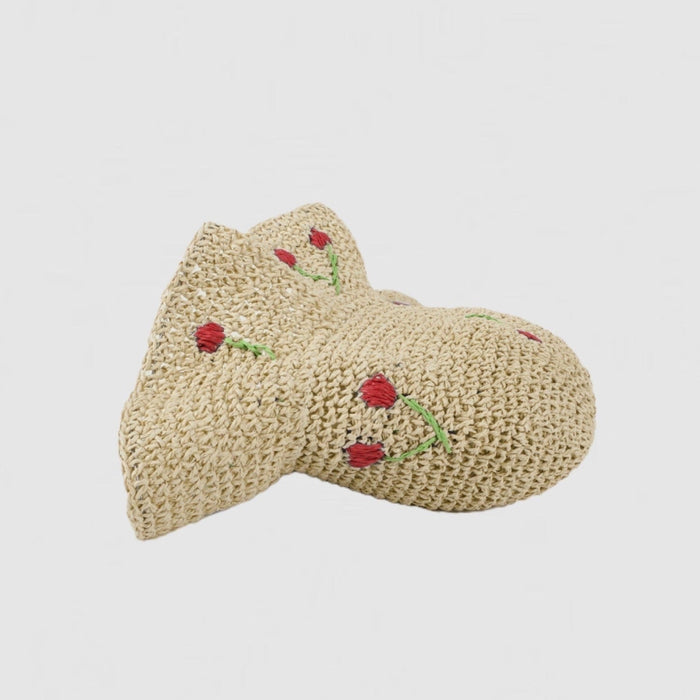 Demonstration showing the foldable and packable design of the straw hat.