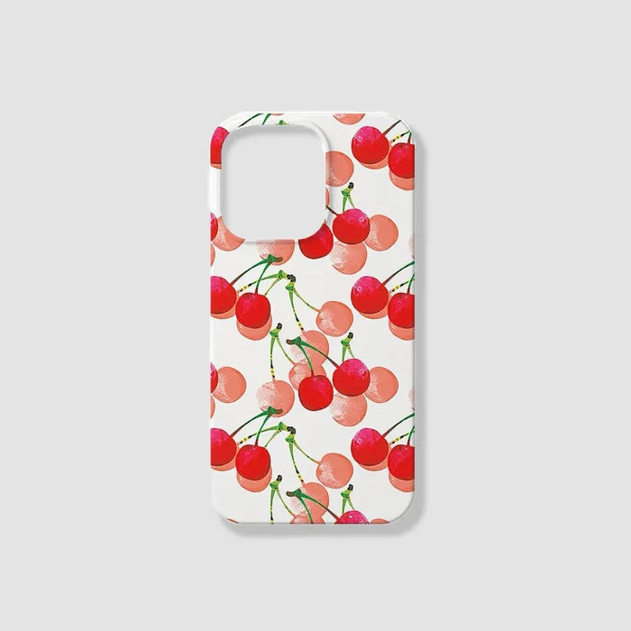 White silicone iPhone case with red cherry pattern and pink polka dots. Cute summery aesthetic cover.