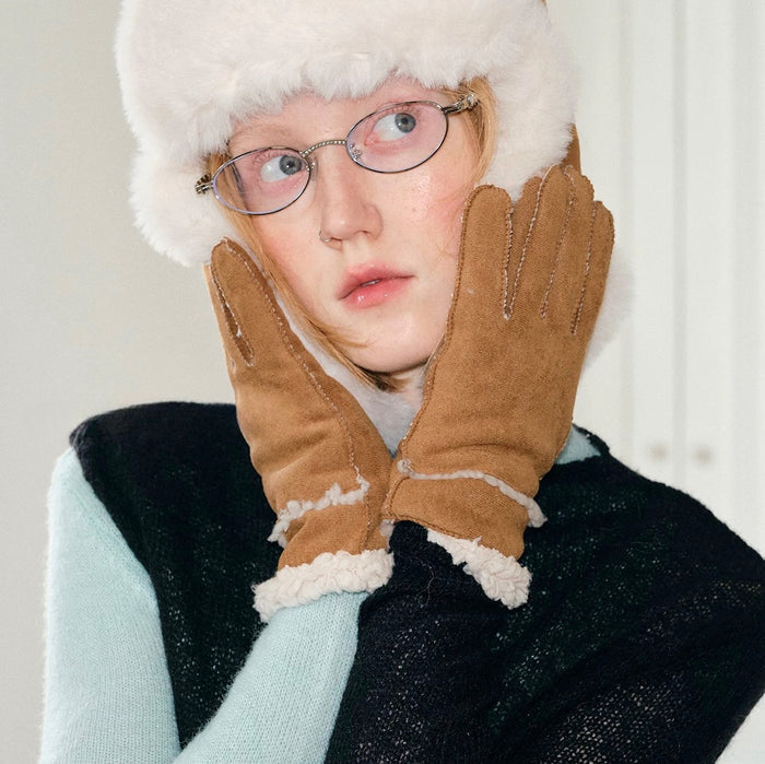 Close-up chestnut suede split-finger gloves with knit cuff and stitching; cozy for cold-weather wear.