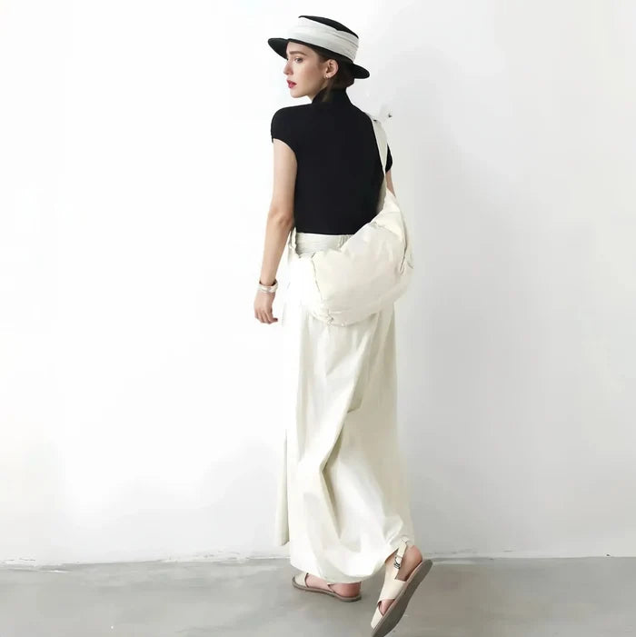 Back view of the off-white crescent bag styled with a minimalist summer outfit.