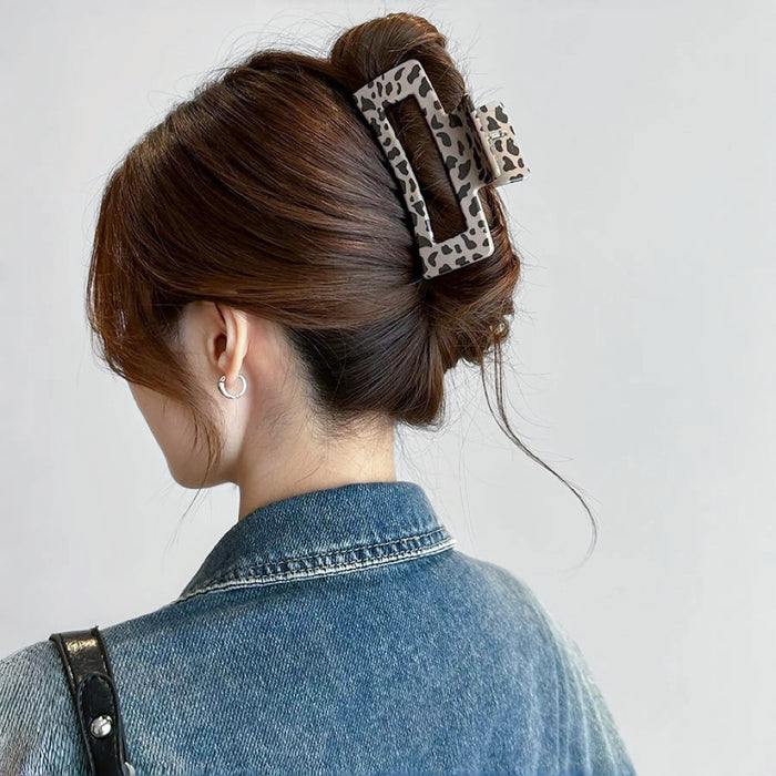 Model wearing a light Chocolate Leopard Print Hair Claw in square style.