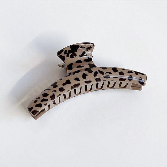 Angled view of light Chocolate Leopard Print Hair Claw in arc shape, great for everyday.