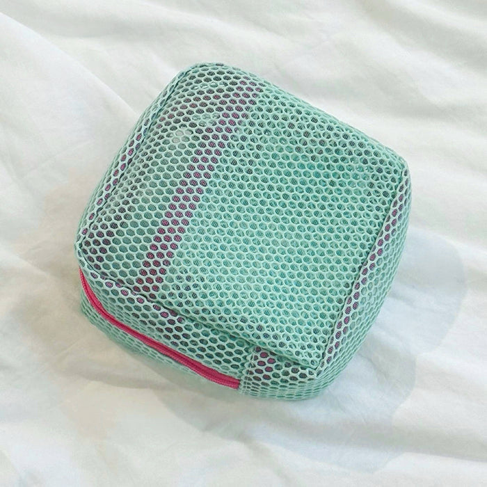 Mint Chroma mesh pouch with pink zipper; airy mesh zip bag for toiletries and quick-dry travel packing.