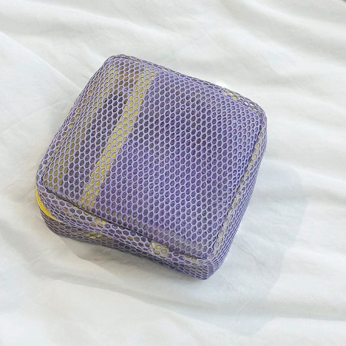 Lilac Chroma mesh pouch with yellow zipper; mesh zip organizer for skincare and small accessories.