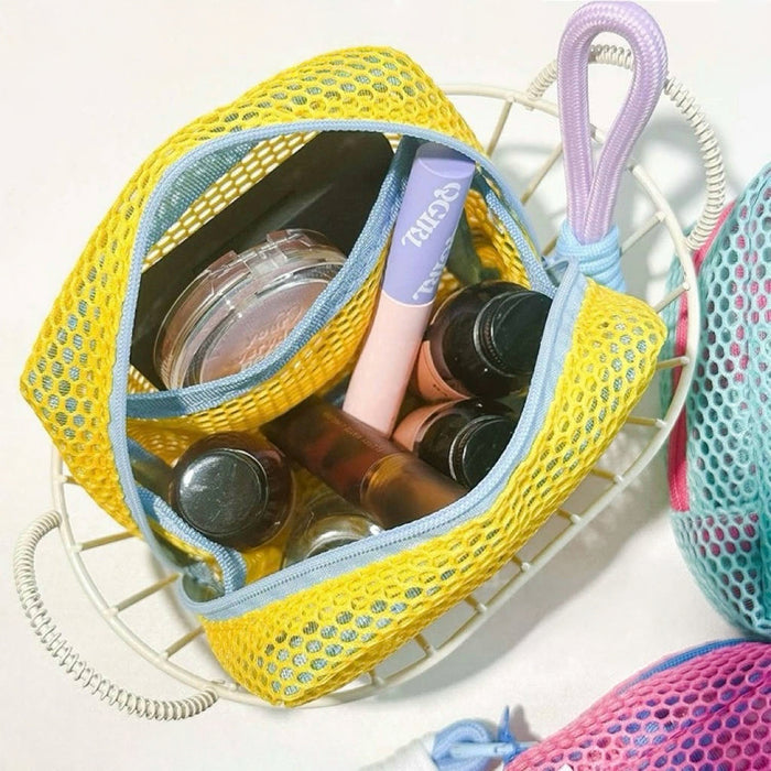 Open yellow Chroma mesh pouch packed with lip balm and bottles; zip makeup organizer for trips and gym bag.