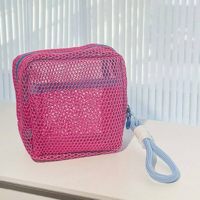 Pink Chroma mesh pouch with blue wrist lanyard; mesh zip cube for quick-grab makeup on the go.