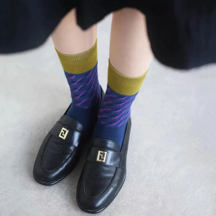 Model wearing a pair of navy blue cotton socks, easy for travel days and daily comfort.