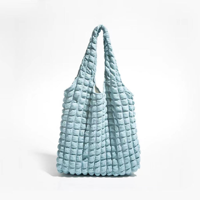 Front view of the light blue bubble textured tote bag against a white background.