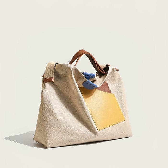 Front view of khaki color-block tote with removable strap highlighting versatile carrying options for urban city walks.