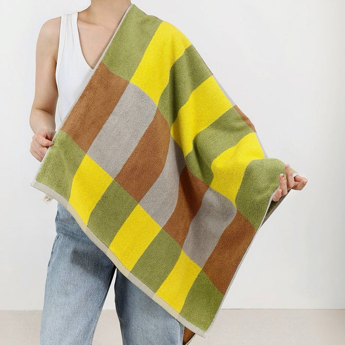 Model is draped in a Yellow-Green Color game plaid bath towel, great for bath time and daily use.