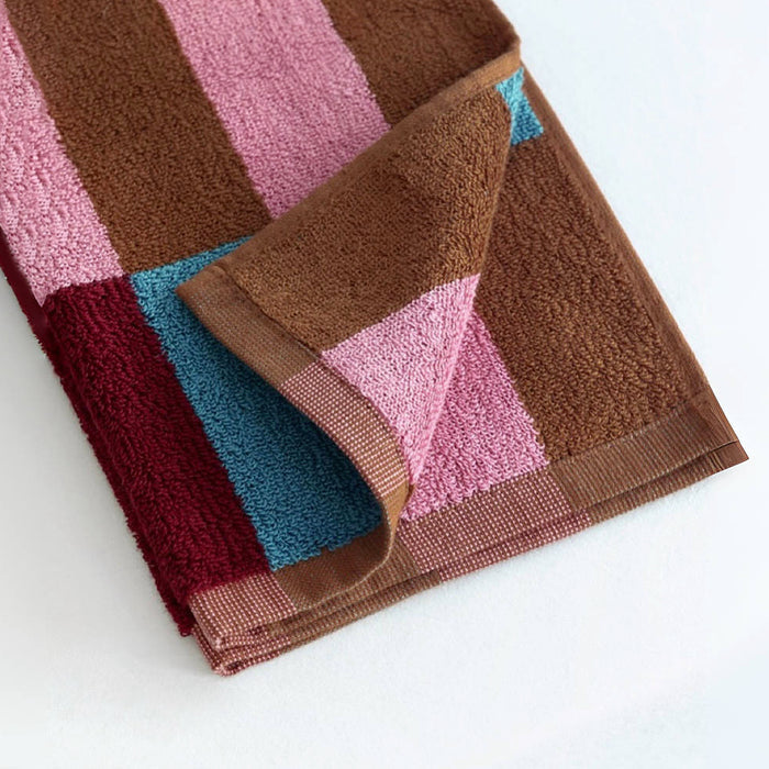 Detail view of Color Game Plaid Face Towel in  Pink-Blue, showcasing cotton fabric and colorful plaid pattern.