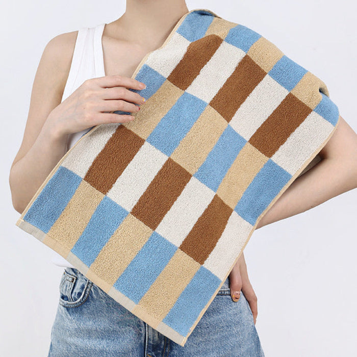 Model is draped in a beige-blue Color Game Plaid Face.