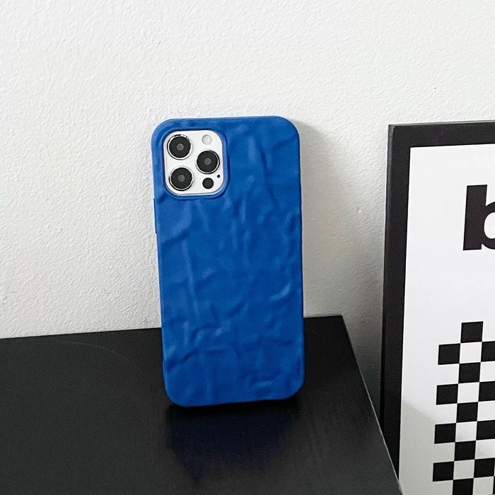 Blue silicone pleated iPhone case. Sleek 3D ripple design with precise camera cutout for minimalist fashion.