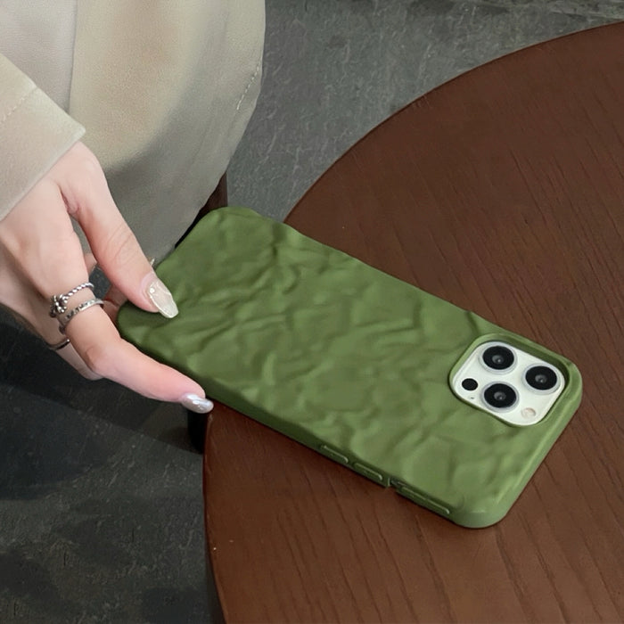 Close-up of green Color Pleated Case. Vibrant multi-tonal pleated texture for a unique tactile grip.