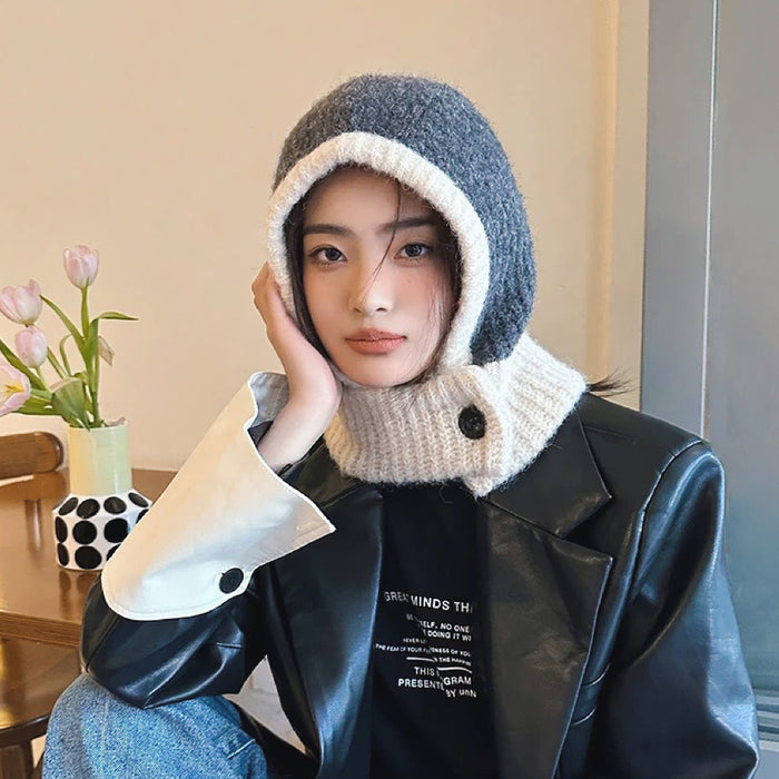 Model wearing grey-beige balaclava hat with bold color-blocked panels in a premium wool-acrylic blend.