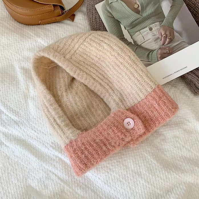 Front view of beige-pink balaclava hat, showcasing an elegant color-spliced design in wool-acrylic.