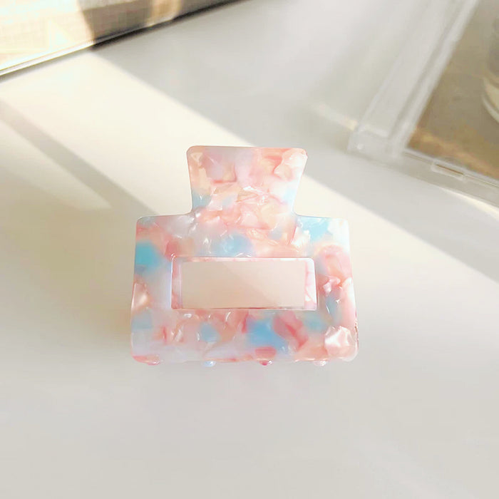 Close-up of Color Square Hair Clawin blue and pink, ideal for quick updos and ponytails.