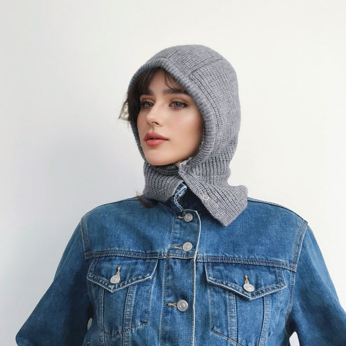 Model wearing grey balaclava hat with vibrant multi-tone patterns, featuring a soft-touch knit finish.