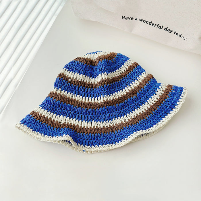 Front view of blue striped foldable straw hat. Refreshing nautical theme for comfortable travel and sunhat.