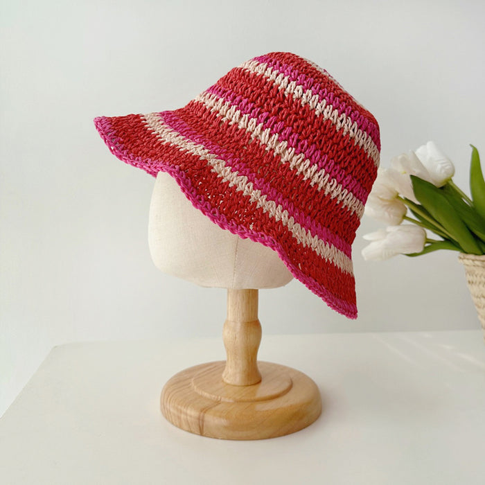 Front view of red striped foldable straw hat. Bold vibrant accent for a standout summer resort look.