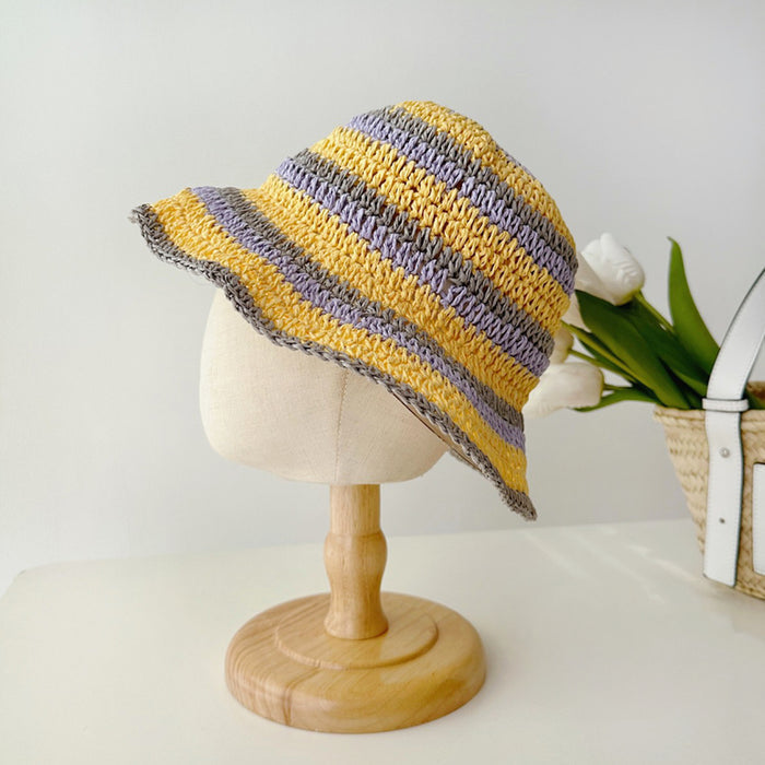 Front view of yellow striped foldable straw hat. Bright cheerful tone on a lightweight natural straw base.