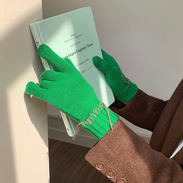 Green colored-thread hemming gloves with contrast stitched seams; warm knit for everyday winter use.