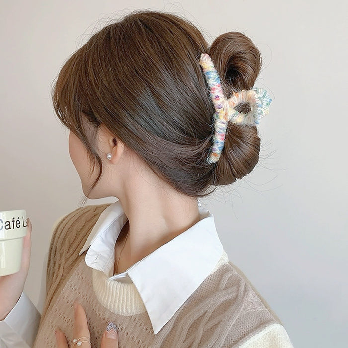 Model wearing  Colored Yarn Hair Claw  in beige, ideal for quick updos and ponytails.