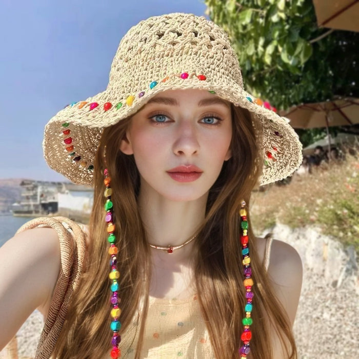 Model wearing the colorful beaded straw hat for a summer vacation look.