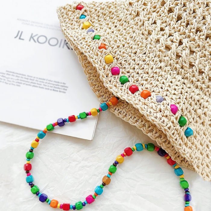 Close-up view of the intricate straw weave and the vibrant bead detailing.