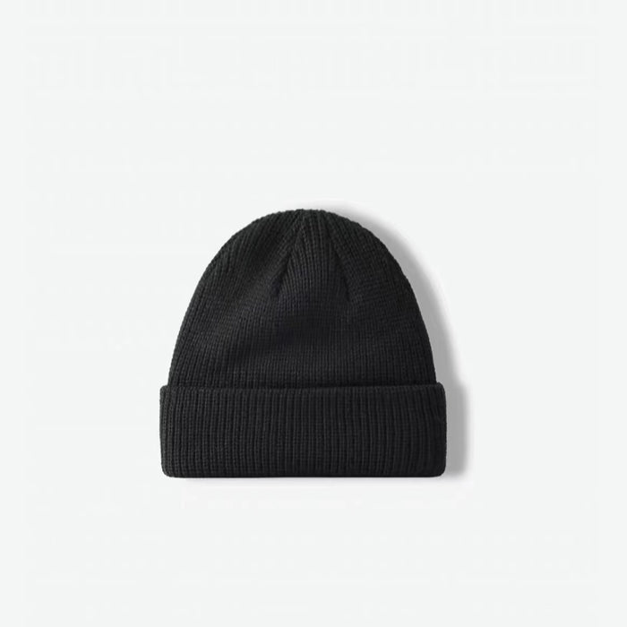 Front view of black multi-color beanie. Subtle dark flecks offer a modern twist on a classic winter staple.