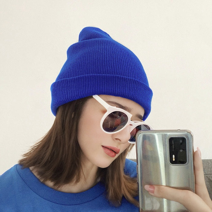 Model wearing klein blue multi-color beanie. Electric blue palette for an edgy and artistic winter look.